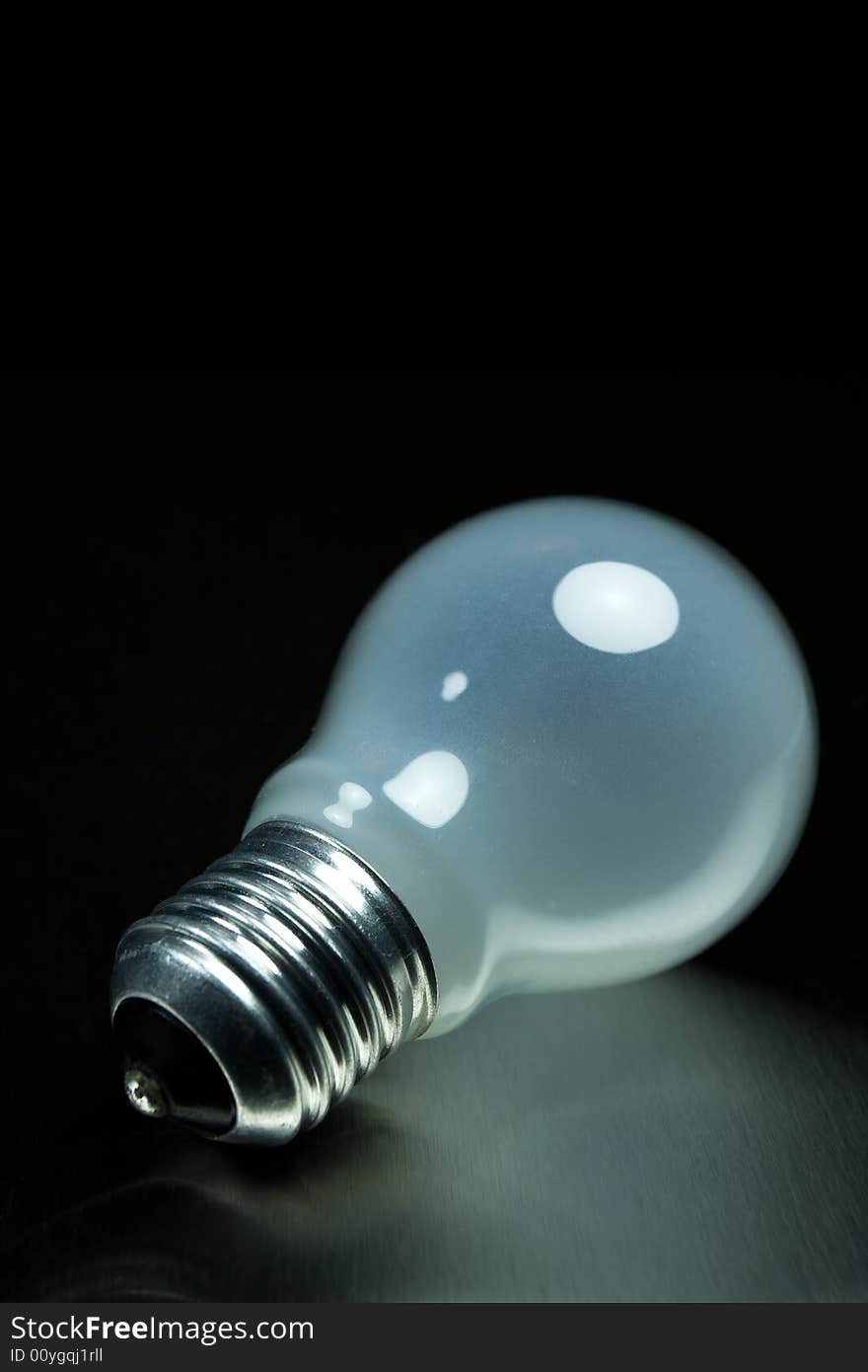 Light bulb on metal desk. Light bulb on metal desk