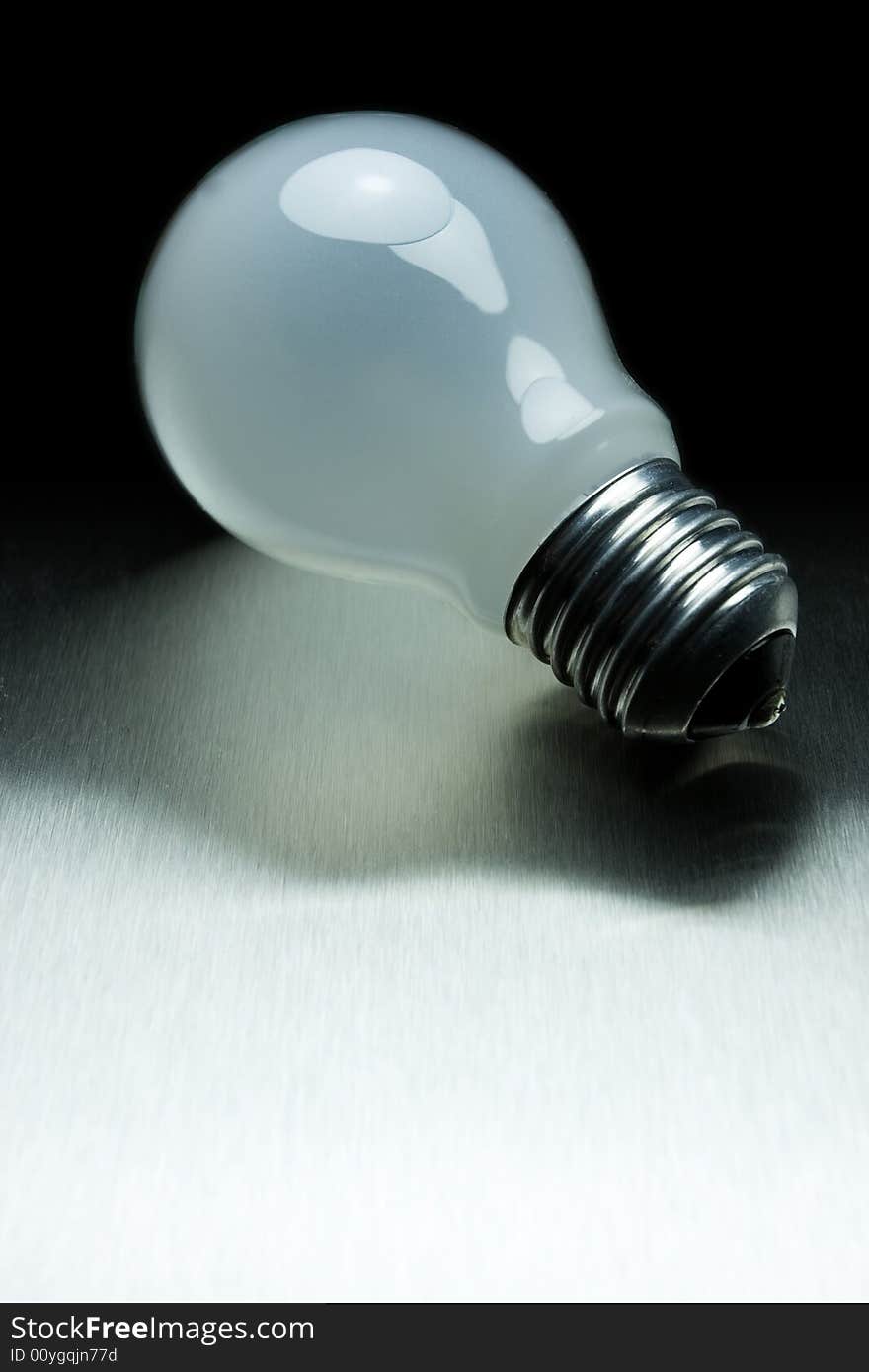 Light bulb on metal desk. Light bulb on metal desk