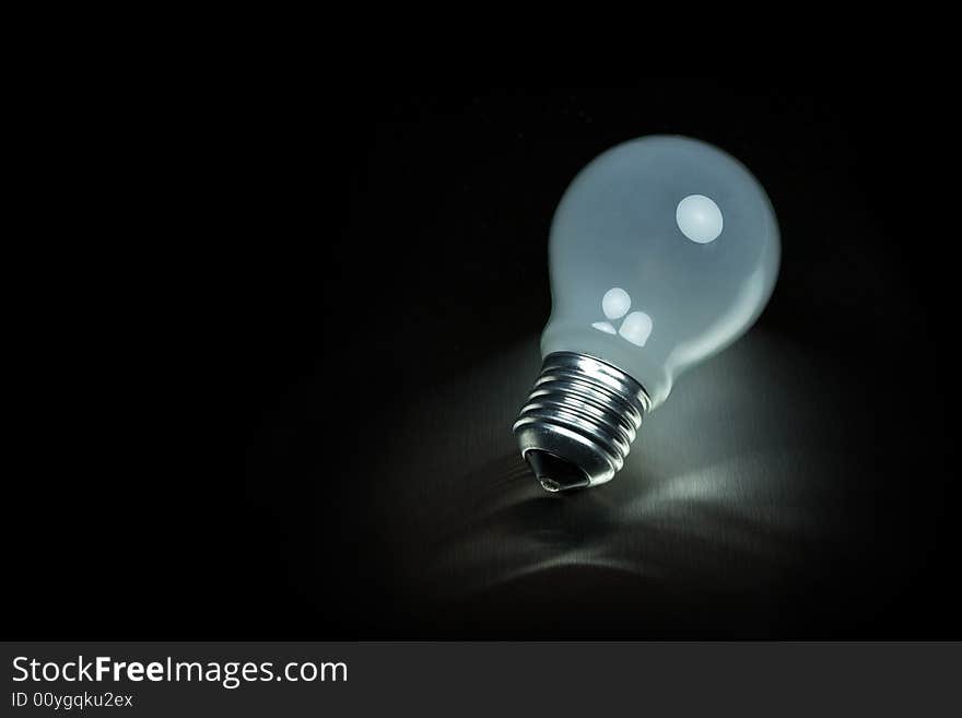 Light bulb on metal desk. Light bulb on metal desk