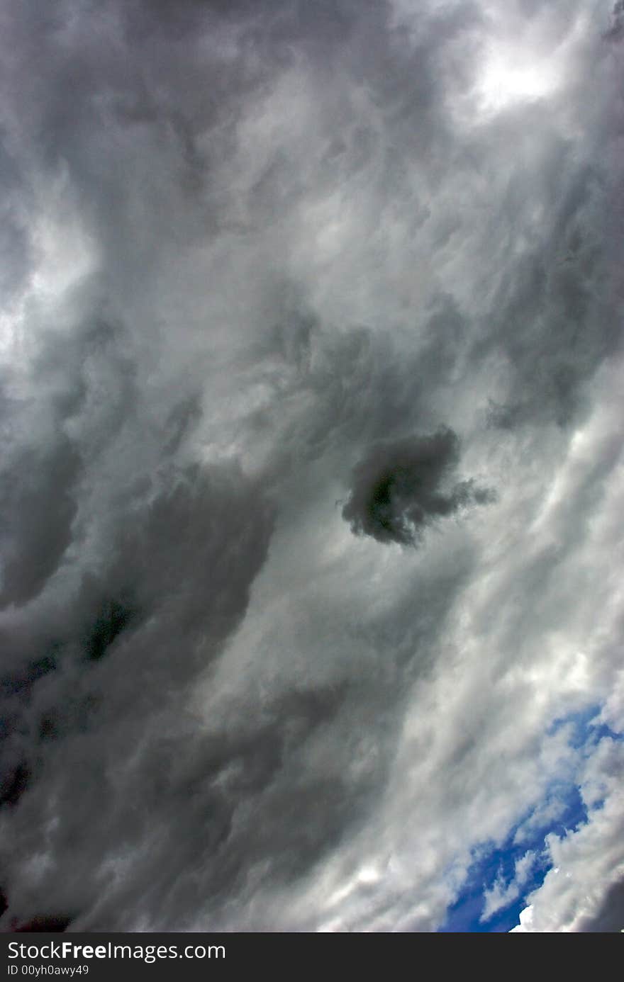 Dramatic clouds fill the sky with deep blue in the background