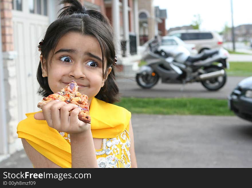 Little Girl Eating A Pizza Slice