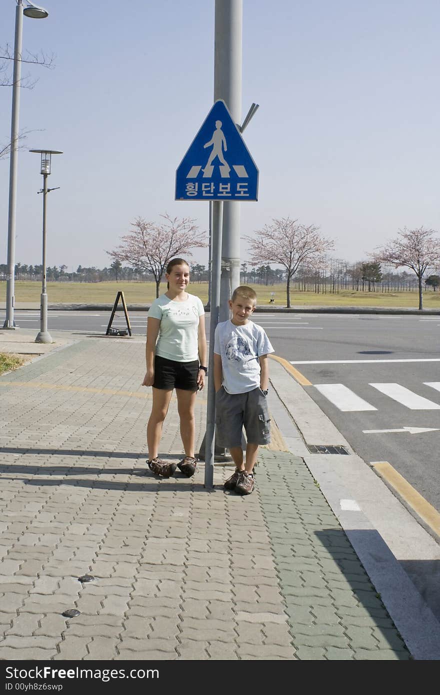 European children at a pedestrian crossing in Korea. European children at a pedestrian crossing in Korea.