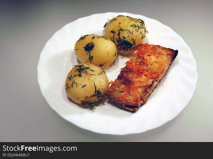 Potato and fish un the plate. Potato and fish un the plate