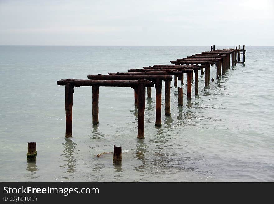 Old pier in the calm sea. Old pier in the calm sea