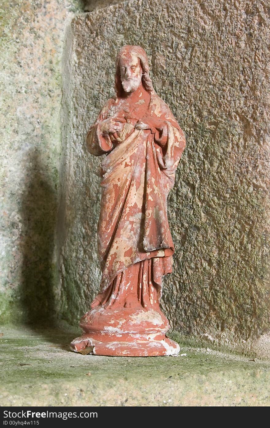 An old plaster statue of jesus christ in an old catholic church in france. An old plaster statue of jesus christ in an old catholic church in france