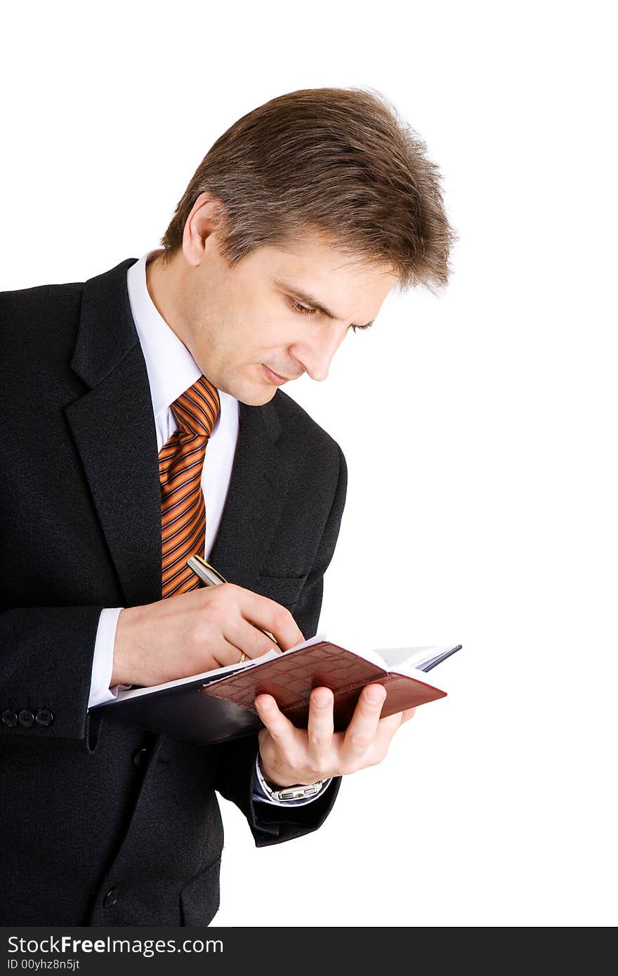 Businessman writing something in his notebook. Businessman writing something in his notebook