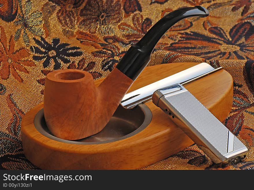 Tobacco pipe and wood ashtray and lighter