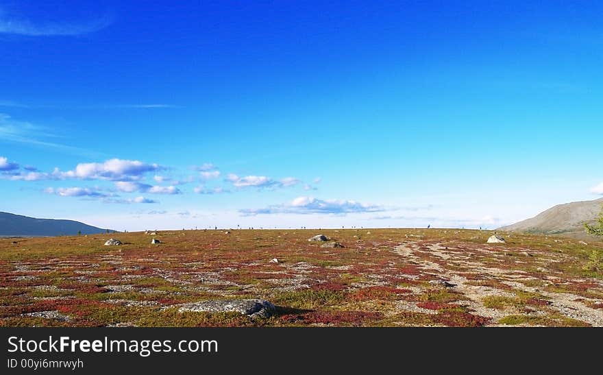 Photo. Tundra. Blue sky. Mountains. Different colors in the tundra. Photo. Tundra. Blue sky. Mountains. Different colors in the tundra.