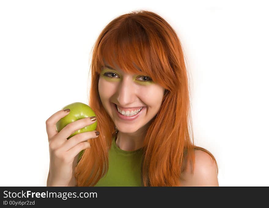 Smiling red-haired girl with green apple isolated on white background