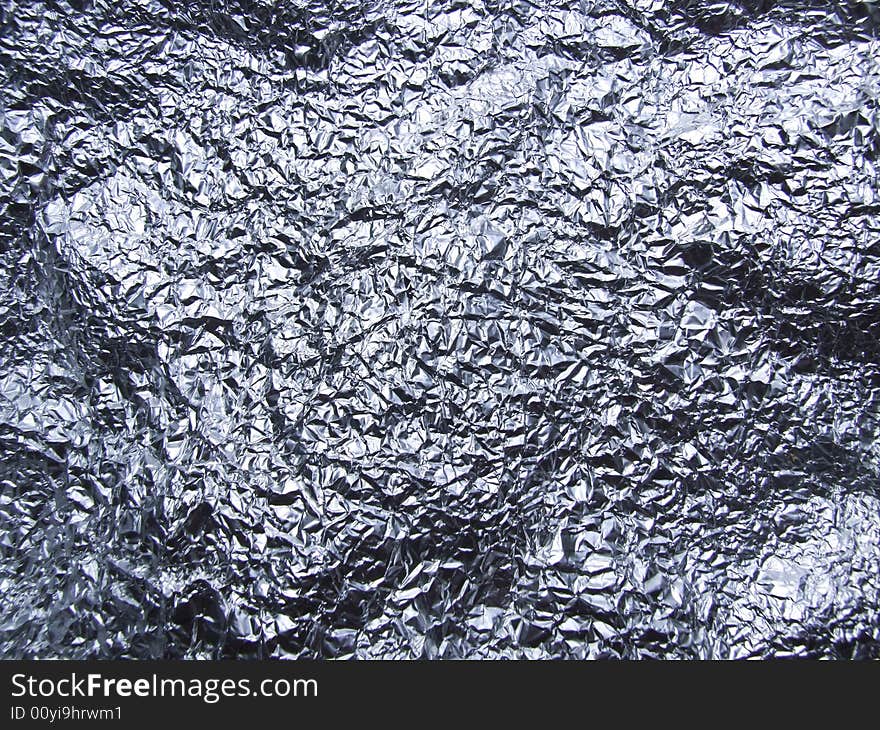 Crumpled tin foil laid flat to make almost landscape type surface.