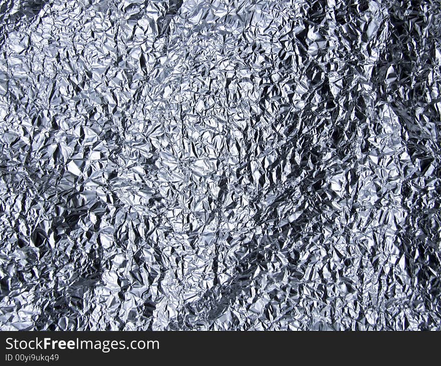 Crumpled tin foil laid flat to make almost landscape type surface.