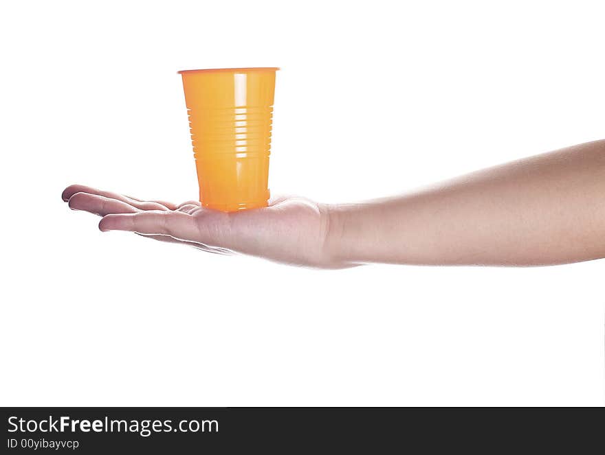 Orange plastic cup in female hand isolated on white.