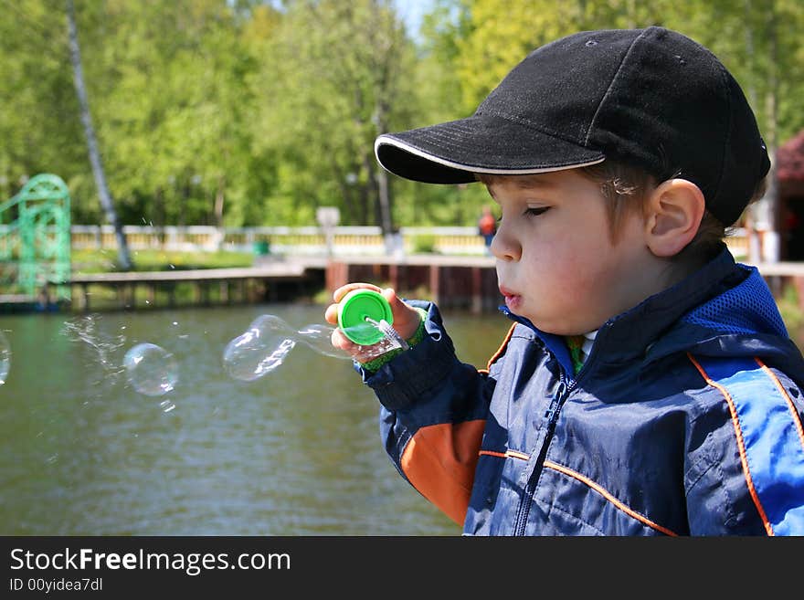 Baby plays with soap bubble