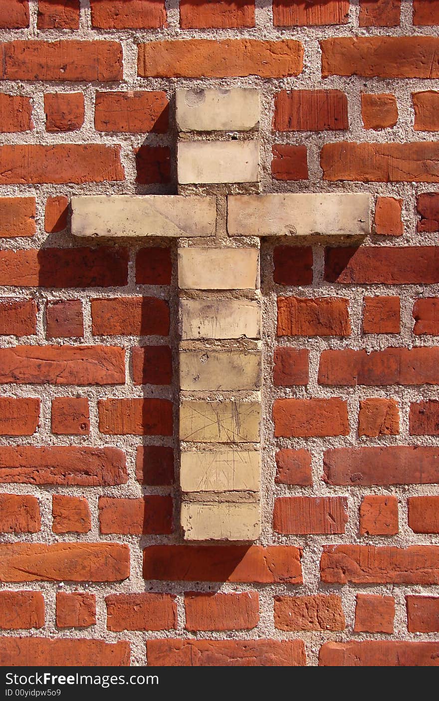 Red brickwall with a cross