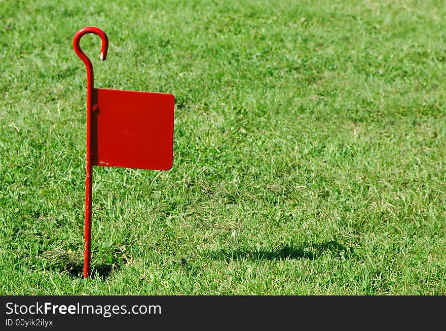 Red flag marker on novelty golf green