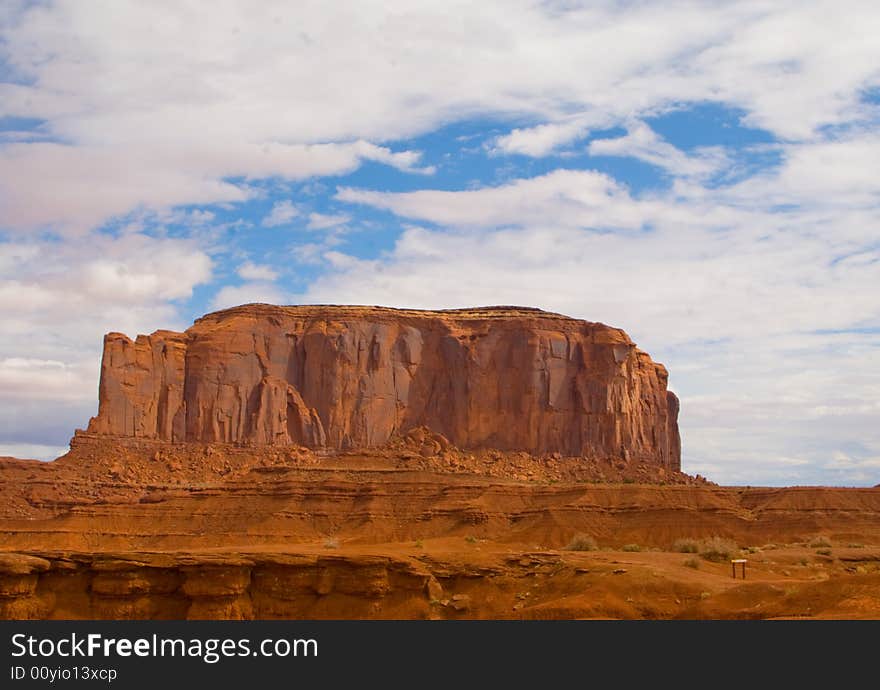 Solitary Butte in Monument Valley under cloudy sky