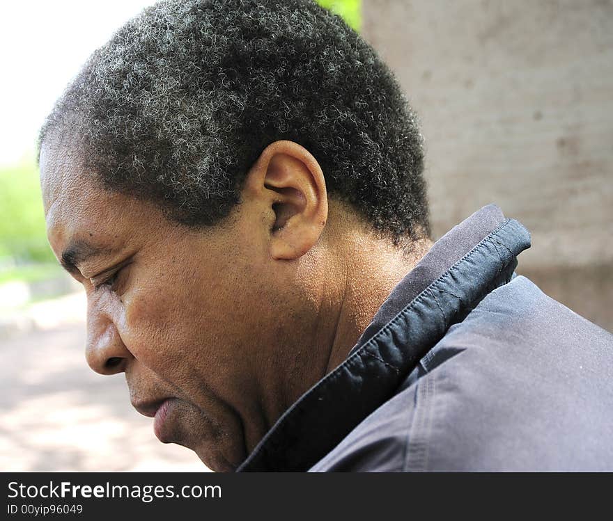 Portrait of a african american male sitting in a park.