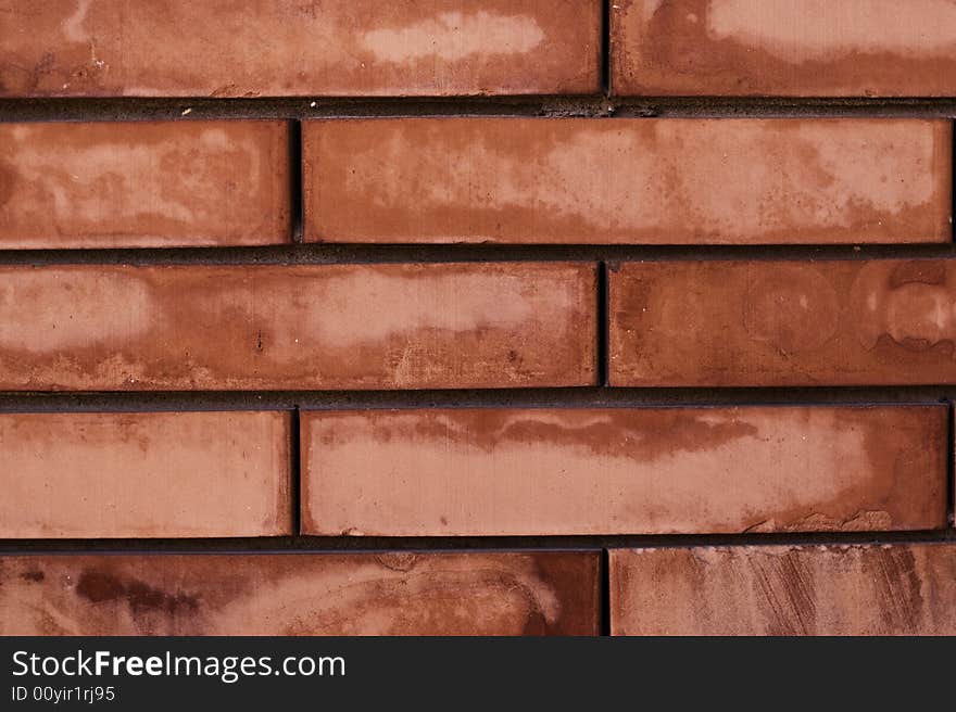 A worn red brick wall texture, or background. A worn red brick wall texture, or background.