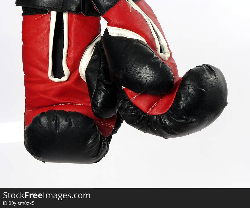 Boxing gloves with a white background hanging up. Boxing gloves with a white background hanging up