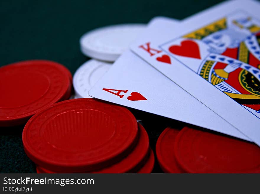 Ace and king of hearts resting on poker chips. Ace and king of hearts resting on poker chips