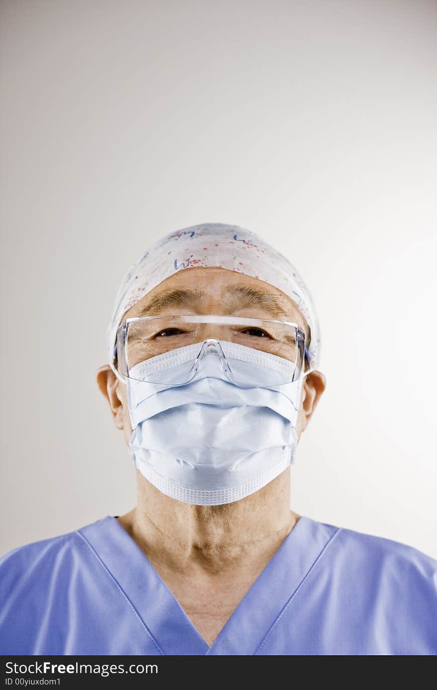 Senior doctor in surgical cap and mask