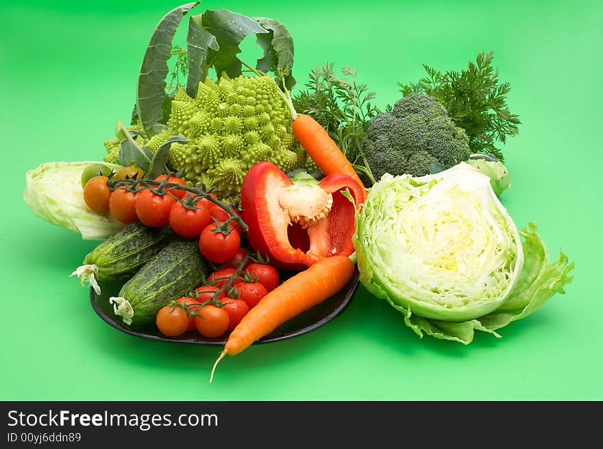 Set of healthy fresh vegetables on green background