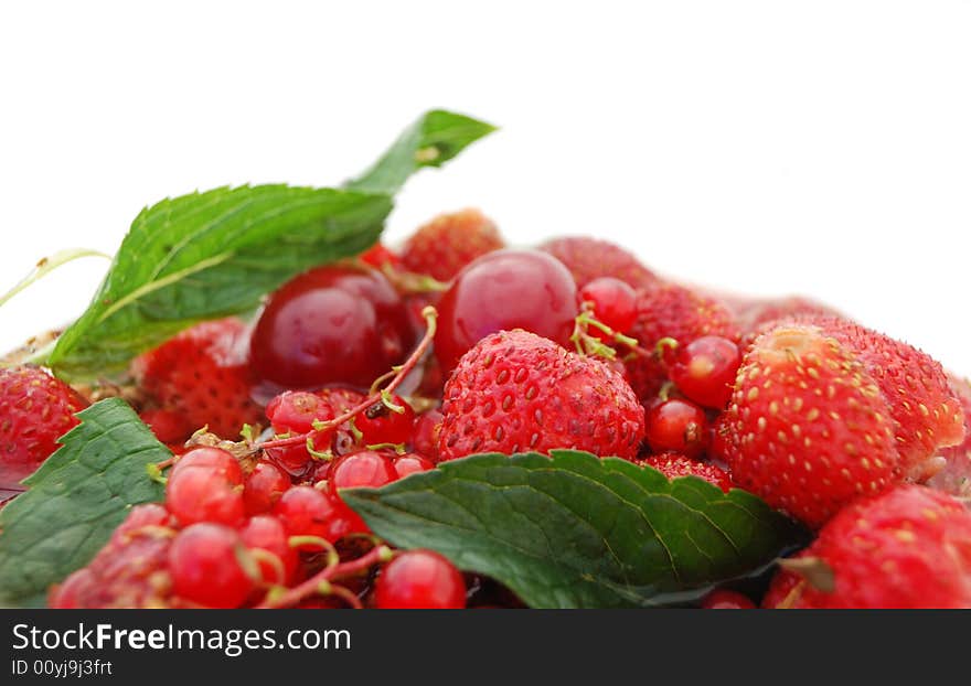 Bright red berries with green leaf on white background