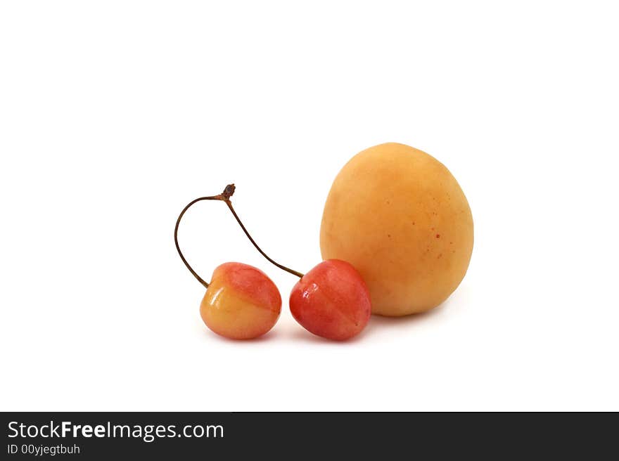 Apricot and sweet cherry on a white background