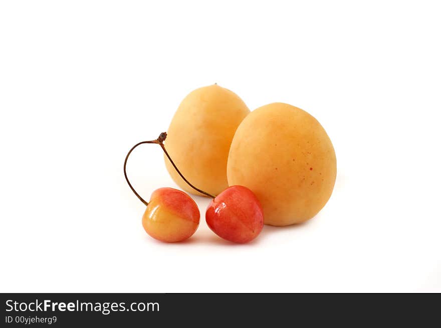 Apricot and sweet cherry on a white background