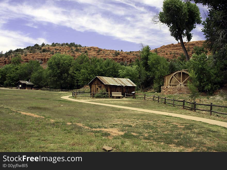 Old wild west sheds and waterwheel near the red mountains of Red Rock Crossing state park in the high desert near Sedona, Arizona. Old wild west sheds and waterwheel near the red mountains of Red Rock Crossing state park in the high desert near Sedona, Arizona