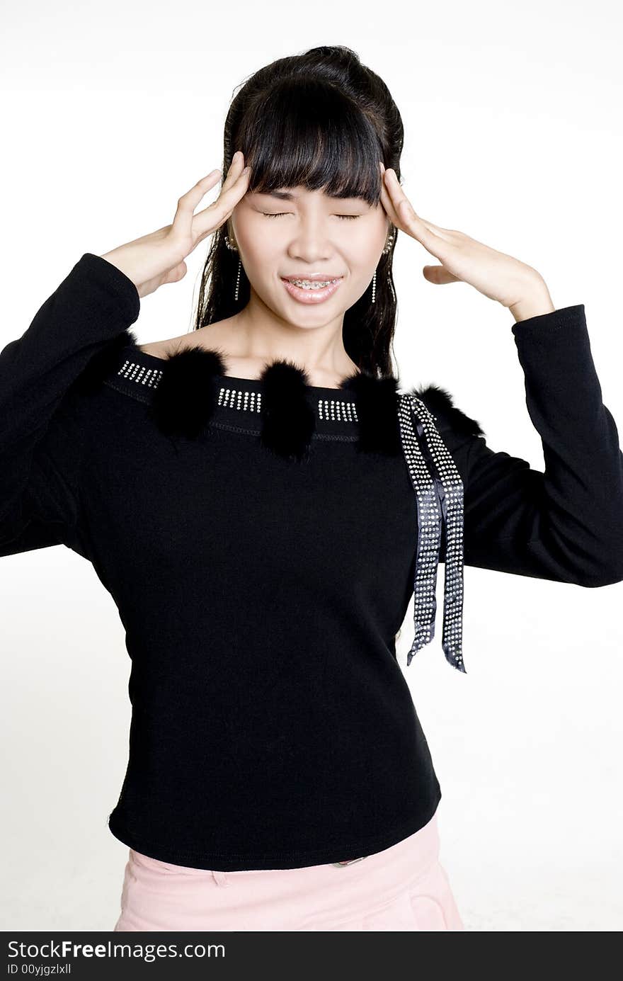 Asian woman with headache against white background