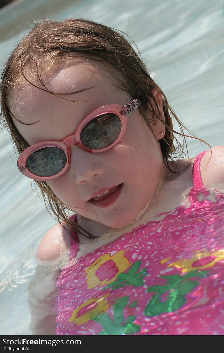 A four year old girl enjoying the pool. A four year old girl enjoying the pool