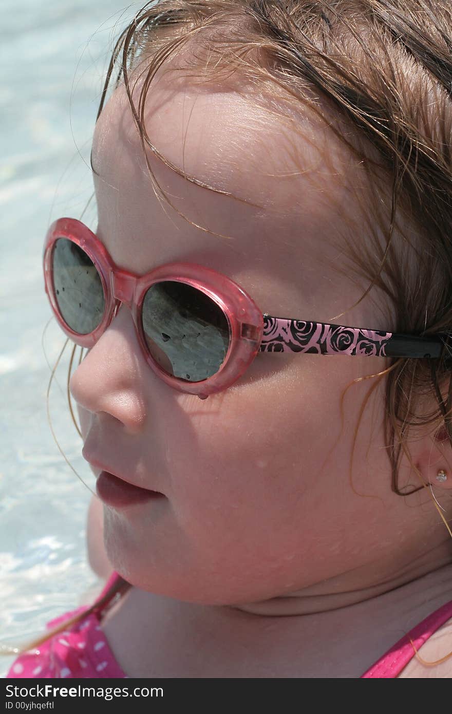 A four year old girl enjoying the pool. A four year old girl enjoying the pool