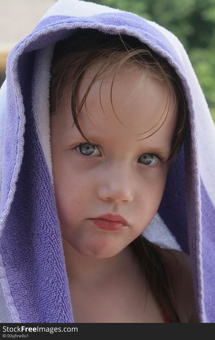 Little girl at the pool with a towel over her head. Little girl at the pool with a towel over her head