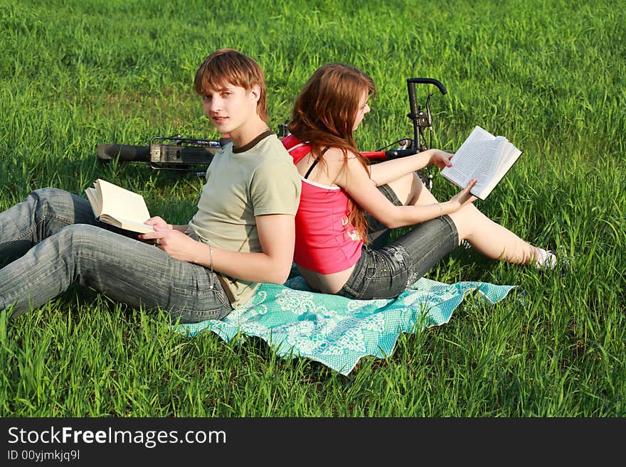 Beautiful couple lying on the grass. Beautiful couple lying on the grass