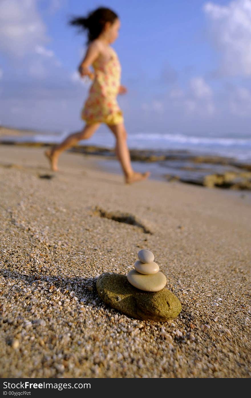 Balancing stones and girl at the beach. Balancing stones and girl at the beach