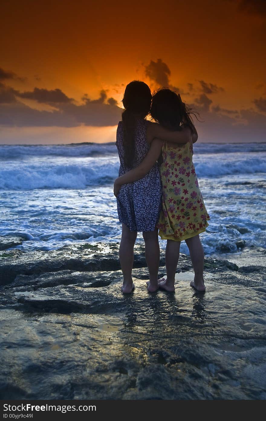 Two girls in the beach at sunset. Two girls in the beach at sunset