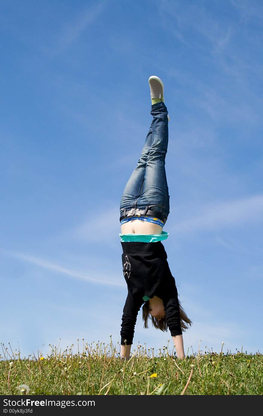 The young happy jumping girl on a background of the blue sky. The young happy jumping girl on a background of the blue sky