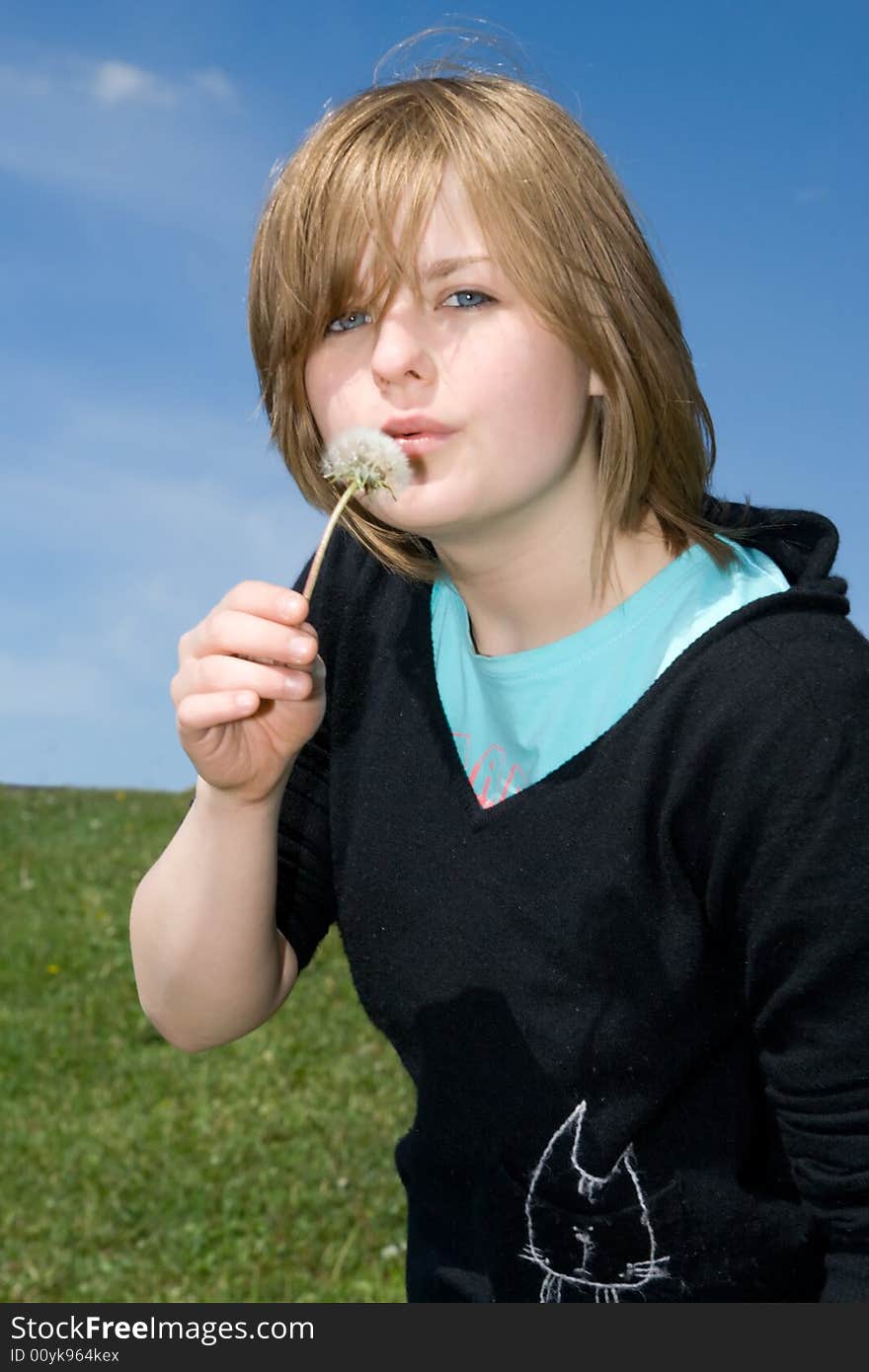 The young girl with a dandelion