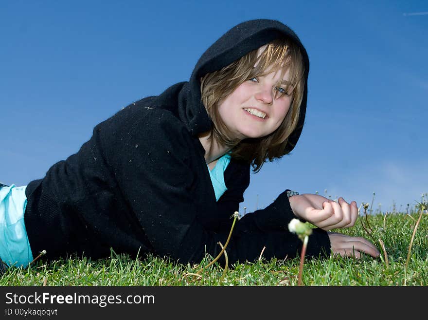 The Young Girl Laying On A Green Grass