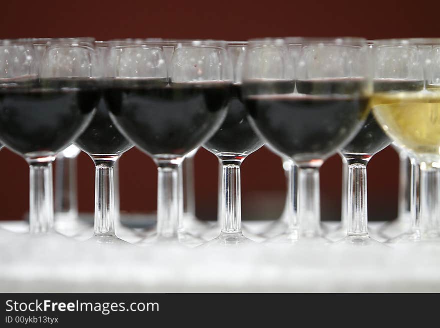 A part with  black and white glasses of wine. A part with  black and white glasses of wine