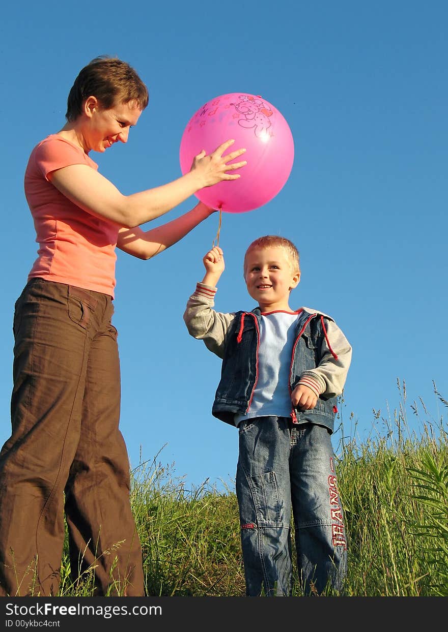 Child and mother play with ball