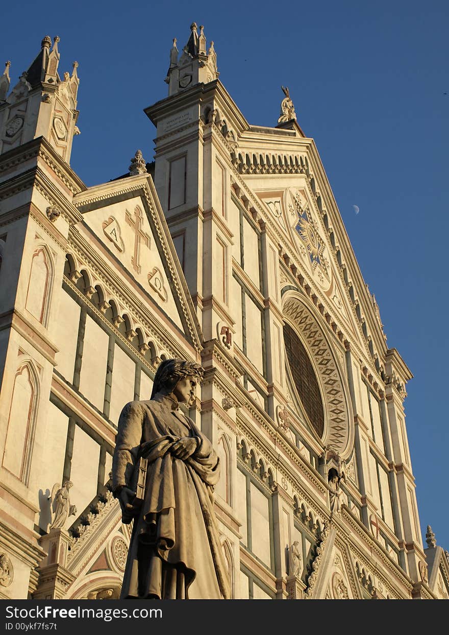 A view of the statue of Dante Alighieri and a glimpse of the facade of Santa Croce Church in Florence- Tuscany. A view of the statue of Dante Alighieri and a glimpse of the facade of Santa Croce Church in Florence- Tuscany