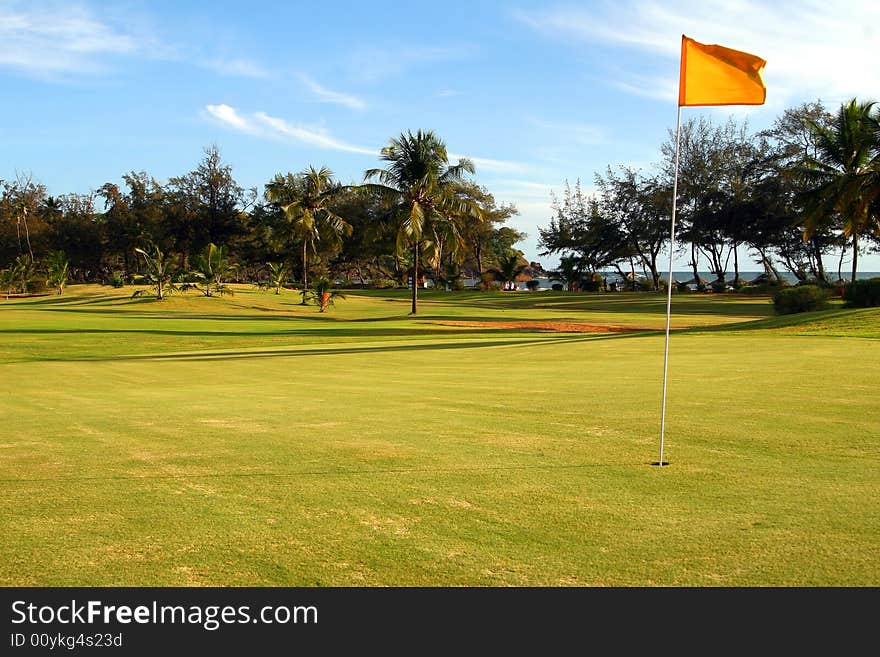 A gorgeous golf course at the ocean shore on a beautiful day. A gorgeous golf course at the ocean shore on a beautiful day.