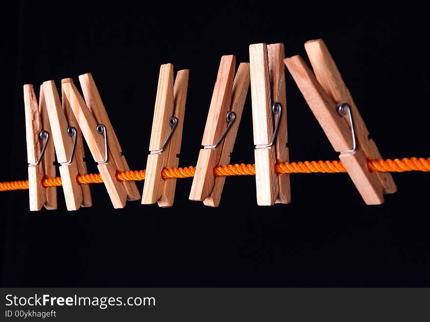 Wooden clips on a orange rope