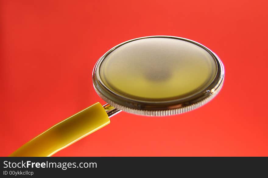 Yellow stethoscope in red background