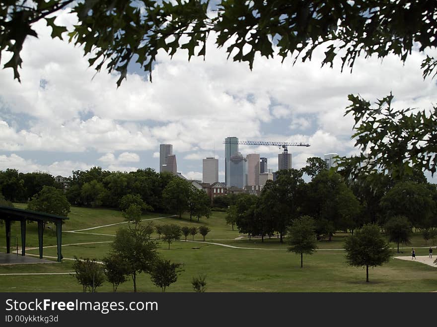 A small urban park providing green space with cityscape in the background. A small urban park providing green space with cityscape in the background.