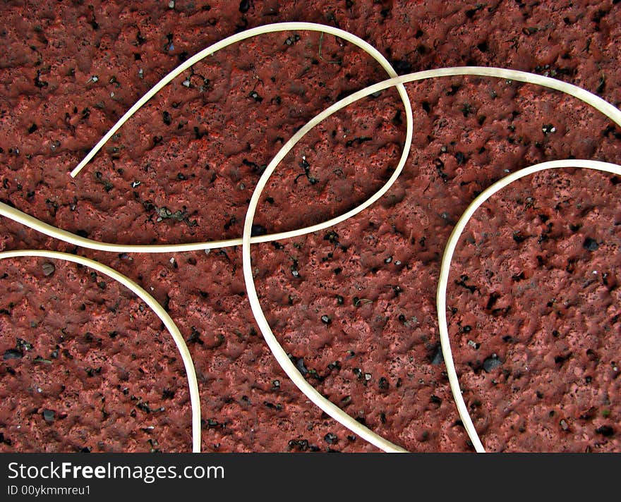 Close-up of white rubber line on red background