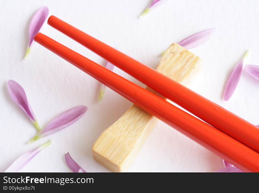 Close up of red sticks with petals