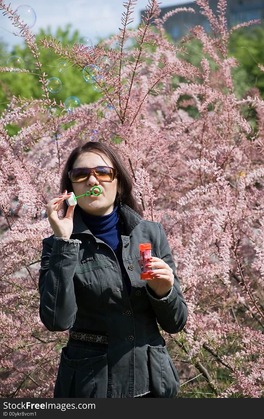 Girl blowing bubble in the park